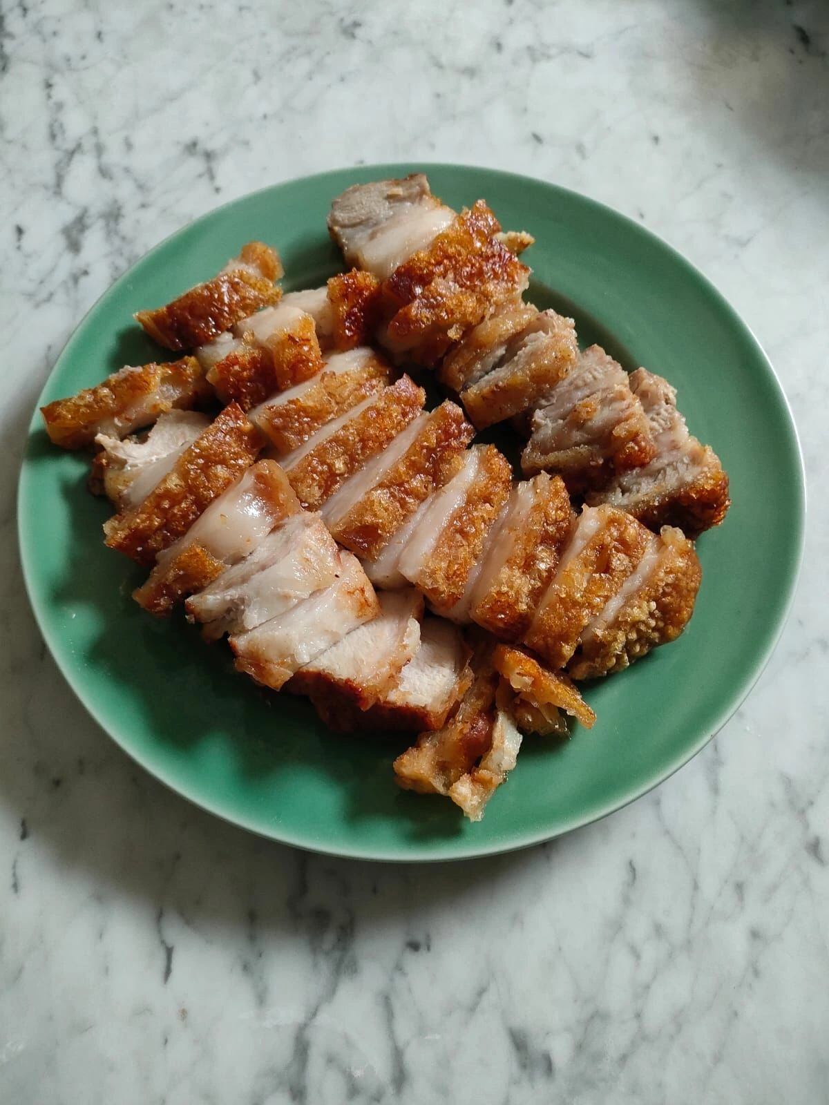 Fresh crispy pork belly (babi panggang krispi) before cutting at KrispiBabi™ kitchen
